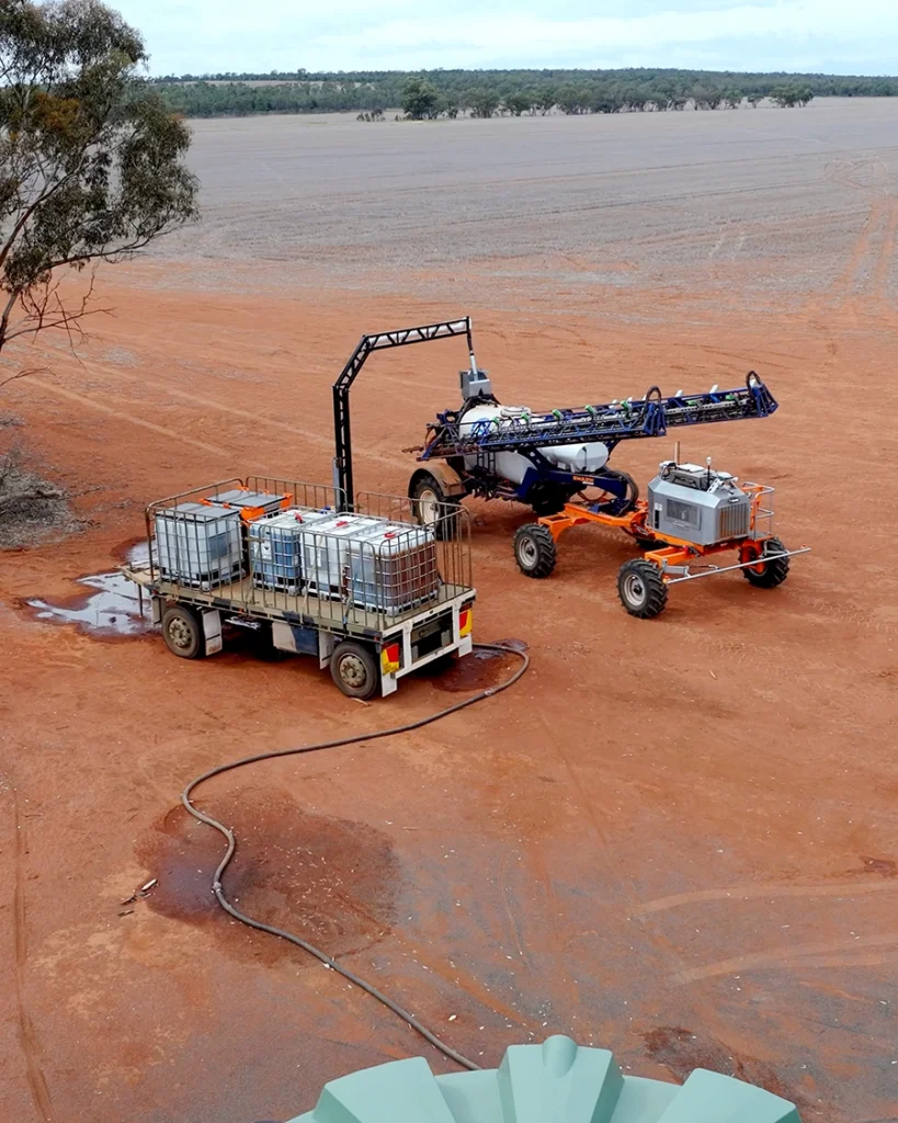 Robotic sprayer Swarmbot refilling before herbicide application.